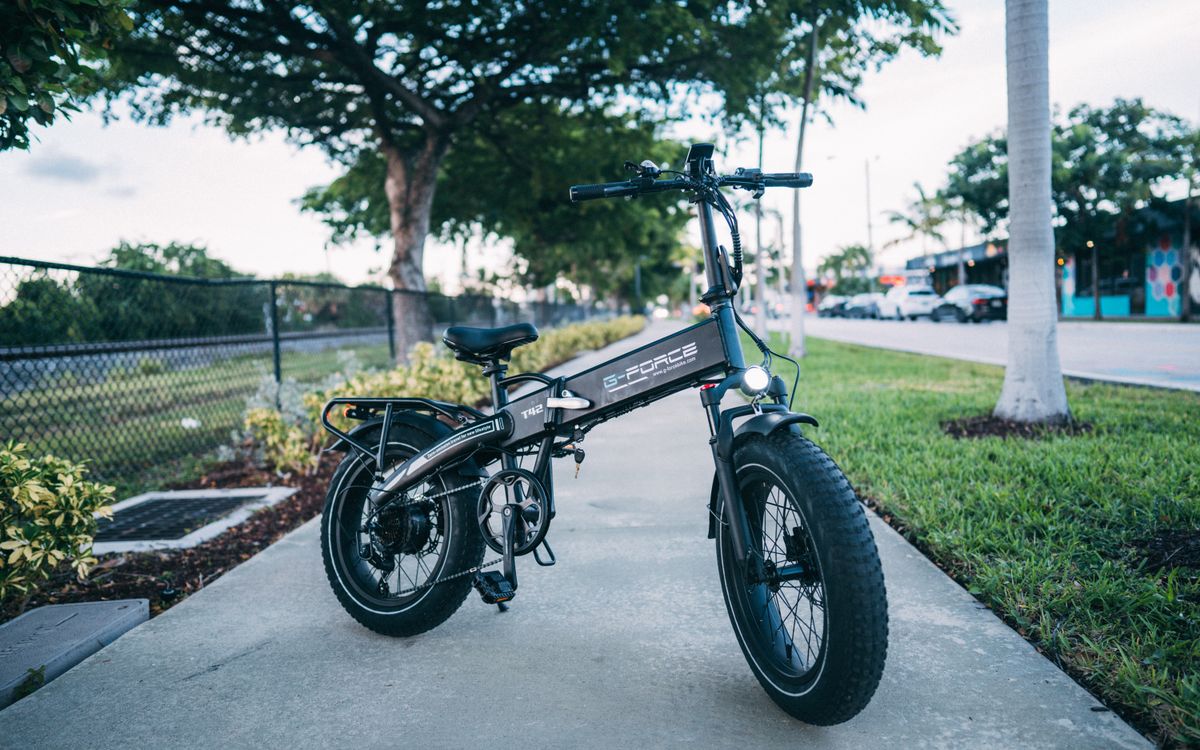 Sleek electric bike parked outdoors surrounded by greenery